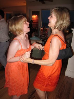light | Batten Disease News | photo of Taylor and her mother, Sharon, wearing orange dresses and dancing together