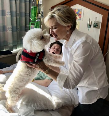 taylor batten | Batten Disease News | Taylor lies in a hospital bed just hours before she took her last breath in 2018. Alongside her is her mother, Sharon, and their dog.
