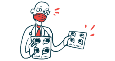 A medical professional is wearing a face mask and holding up two charts.