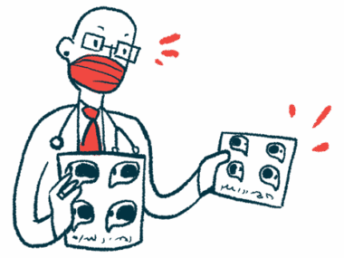 A medical professional is wearing a face mask and holding up two charts.